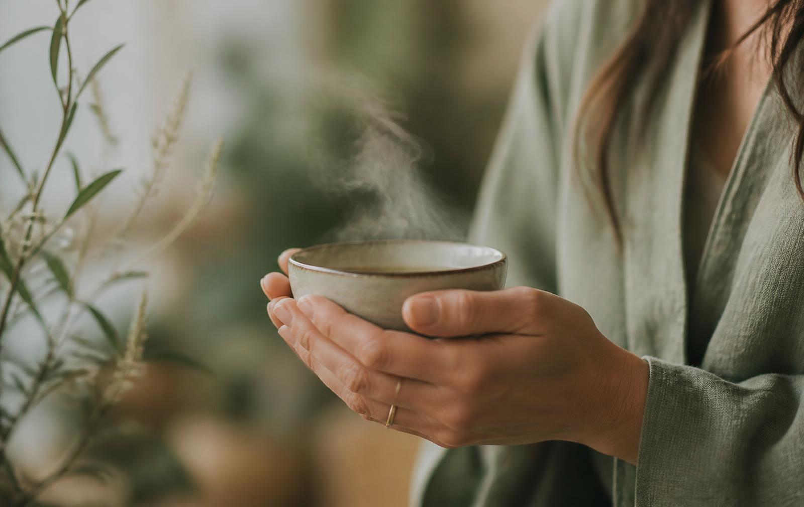 A quiet wellness moment — hands cradling warmth